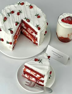 two plates with slices of strawberry cake on them