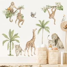 there are many animals on the wall in this children's room, including monkeys and giraffes