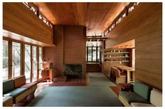 a living room filled with lots of furniture next to a fire place in a building