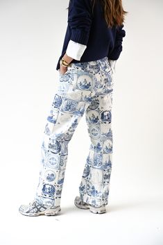 Our straight leg jean in a cream wash base, with an all-over Delft tile print and script embroidery on the back. The print showcases several handdrawn tiles inspired by 17th century Dutch 'delftware' and the pant is complete with Yellow-branded metal snap closure at front. Porcelain base with Delft Blue artwork Mid-rise inseam Straight leg fit Clean hem Non-stretch cotton fabric 'Sisters II' artwork tile by Lauren Fuhr 100% cotton run LARGE — consider sizing down All orders ship from our warehou Script Embroidery, Delft Tiles, Blue Artwork, Stretch Cotton Fabric, Delft Blue, Tile Print, Delft, 17th Century, Stretch Cotton