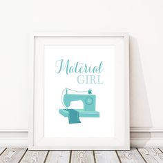 a white frame with a blue sewing machine on it and the words, material girl