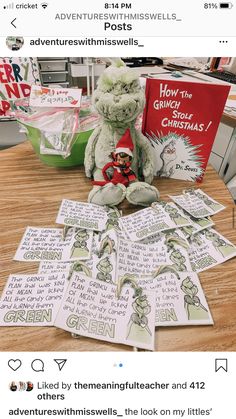 a teddy bear sitting on top of a wooden table next to some christmas greetings