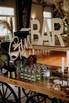 the bar is set up with liquor bottles and candles