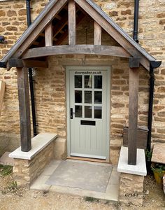 a white door sitting in front of a stone building