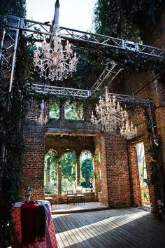 the inside of an old brick building with chandelier