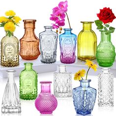 there are many different colored vases with flowers in them