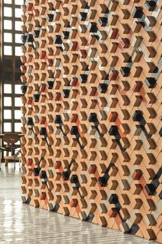 a wall made out of wooden blocks with geometric designs