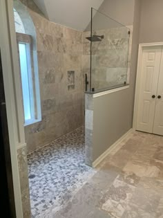 a walk in shower sitting inside of a bathroom