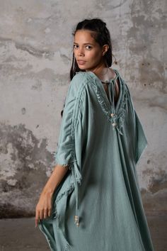 PUSKUL Kaftan embodies the essence of boho-chic, a natural and ethereal dress that effortlessly combines comfort and style. Crafted from the softest cotton available, this dress will envelop your skin like a gentle, warm embrace. PUSKUL Kaftan is versatile and can be worn on any occasion, from the dance floors to formal events, street wear to desert outfits. You can also wear it in two distinct styles: as a kaftan or as a sultry dress, simply by changing the way you put it on! Puskul Kaftan is e Chic Cotton Maxi Dress For Beach Cover-up, Bohemian Tunic Dress Relaxed Fit, Bohemian Relaxed Fit Tunic Dress, Bohemian V-neck Dress With Natural Dye, Cotton Vacation Dresses With Back Tassel Tie-up, Bohemian Tunic Maxi Dress, Bohemian Linen Dress, Cotton V-neck Boho Hippie Dress, Relaxed Fit Bohemian Tunic Maxi Dress