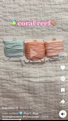 two skeins of yarn sitting on top of a white sheet with the words coral reef