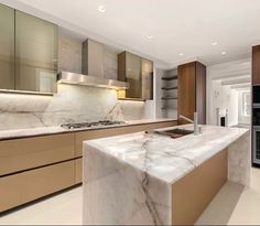 a kitchen with marble counter tops and wooden cabinets