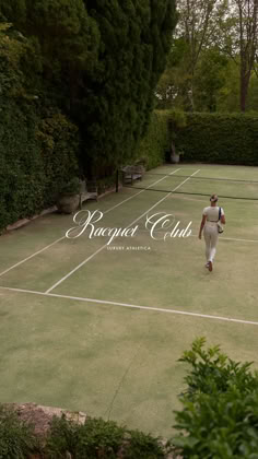 a man walking across a tennis court with a racquet in his hand and the words roger club on it