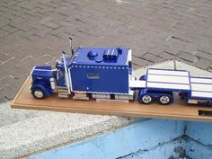 a toy truck is sitting on a wooden shelf