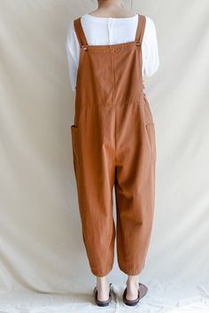 Brown Cotton Overalls For Spring, Cotton Overalls With Bib Front, Solid Cotton Overalls With Bib Front, Brown Cotton Relaxed Fit Jumpsuits And Rompers, Solid Cotton Bib Front Overalls, Cotton Bib Front Overalls In Solid Color, Brown Cotton Overalls With Pockets, Brown Cotton Overalls, Cotton Shortalls For Workwear In Fall