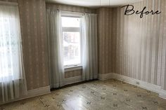 an empty living room with striped walls and wood flooring that has been stripped off