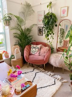 a living room filled with lots of plants next to a mirror and couch in front of a window