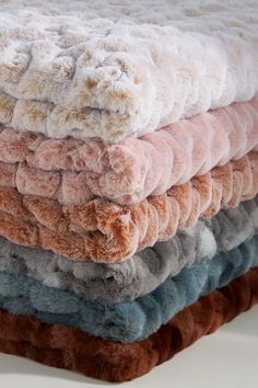 a pile of blankets stacked on top of each other