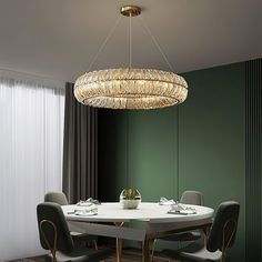 a dining room table with chairs and a chandelier hanging from it's ceiling