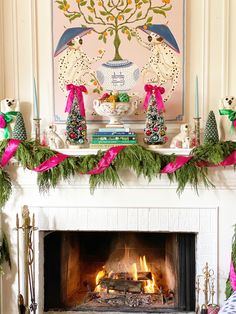 a fireplace decorated for christmas with pink and green decorations