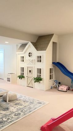 a child's play room with a slide and toy house in the back ground