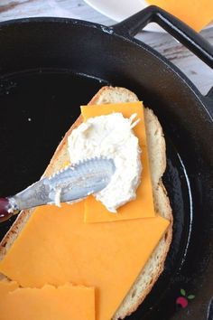 a sandwich with cheese and butter in a skillet