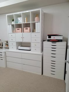 a room with white furniture and drawers in it