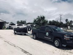 a black truck pulling a trailer behind it