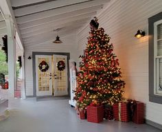 a decorated christmas tree on the front porch