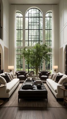 a living room filled with furniture and large windows