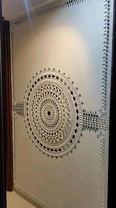 a white wall with an intricate design on it