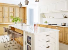 a kitchen with white cabinets and an island in the middle is featured on instagram