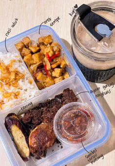 a plastic container filled with rice, meat and other food items next to a drink