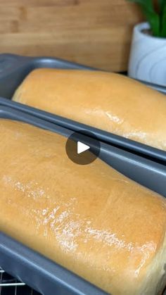 two loaves of bread cooling on a rack