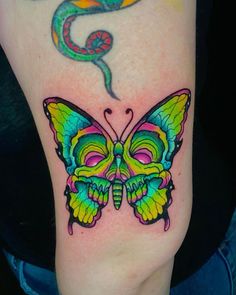 a colorful butterfly tattoo with a snake on it