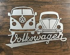 volkswagen vw bus and van die cut out on wood background with the word volkswagen written in large letters