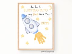 a baby's first new year card with a rocket ship on it