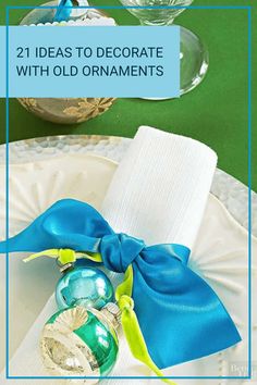 a white plate topped with blue and green christmas ornaments next to a napkin on top of it