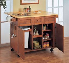 a kitchen island cart with two drawers and an open door on the side that has food in it