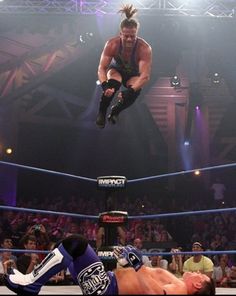 the wrestler is in mid air after falling off his knees