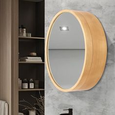 a bathroom with a sink, mirror and shelving unit in the wall next to it