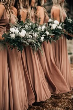 the bridesmaids are holding their bouquets and looking at each other in different directions