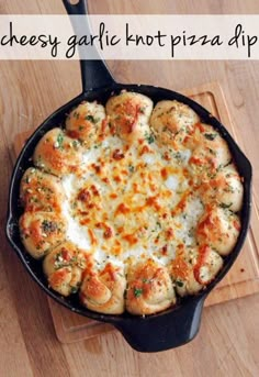 cheesy garlic hot pizza dip in a cast iron skillet on a cutting board