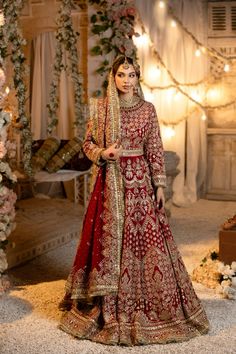 a woman in a red and gold bridal gown