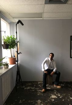 a man is sitting in an empty room