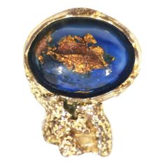 The YSL (Yves Saint Laurent) Arty Ring, also known as the YSL Arty Ovale Ring, is a popular and iconic fashion accessory that was available in a variety of colors and materials. This ring was known for its large, bold design and featured a large, oval-shaped stone set in a textured, gold-tone frame. The stone in this ring was typically made of colored glass or resin with a marbled or multicolored appearance. The "Vintage YSL Gold Massive Blue Multicolour Stone Arty Ring in Size 6" you mentioned Ysl Arty Ring, Ysl Ring, Saint Laurent Ring, Ysl Jewelry, Bezel Set Diamond Ring, Versace Gold, Lucid Dream, Vintage Ysl, Iconic Fashion