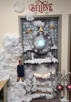 a man standing in front of a door decorated with fake clouds and a train on it