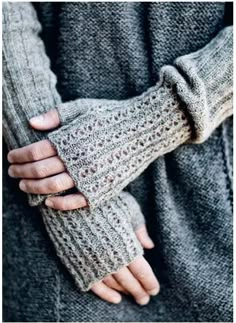 a woman's hands in knitted gloves