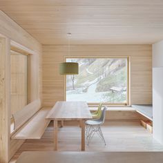 a dining room with wooden walls and flooring