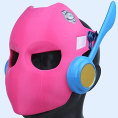 a pink mask with blue earpieces on top of it