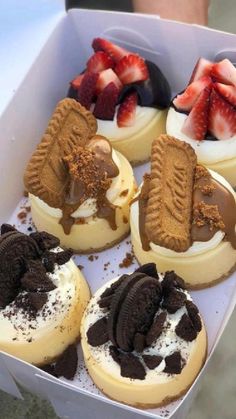 a box filled with assorted desserts sitting on top of a table